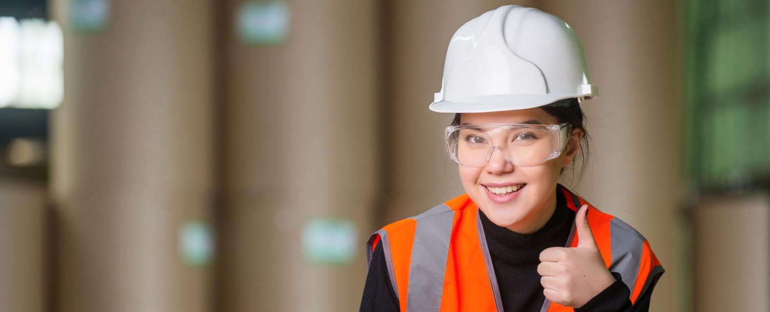 Woman on construction site giving thumbs up