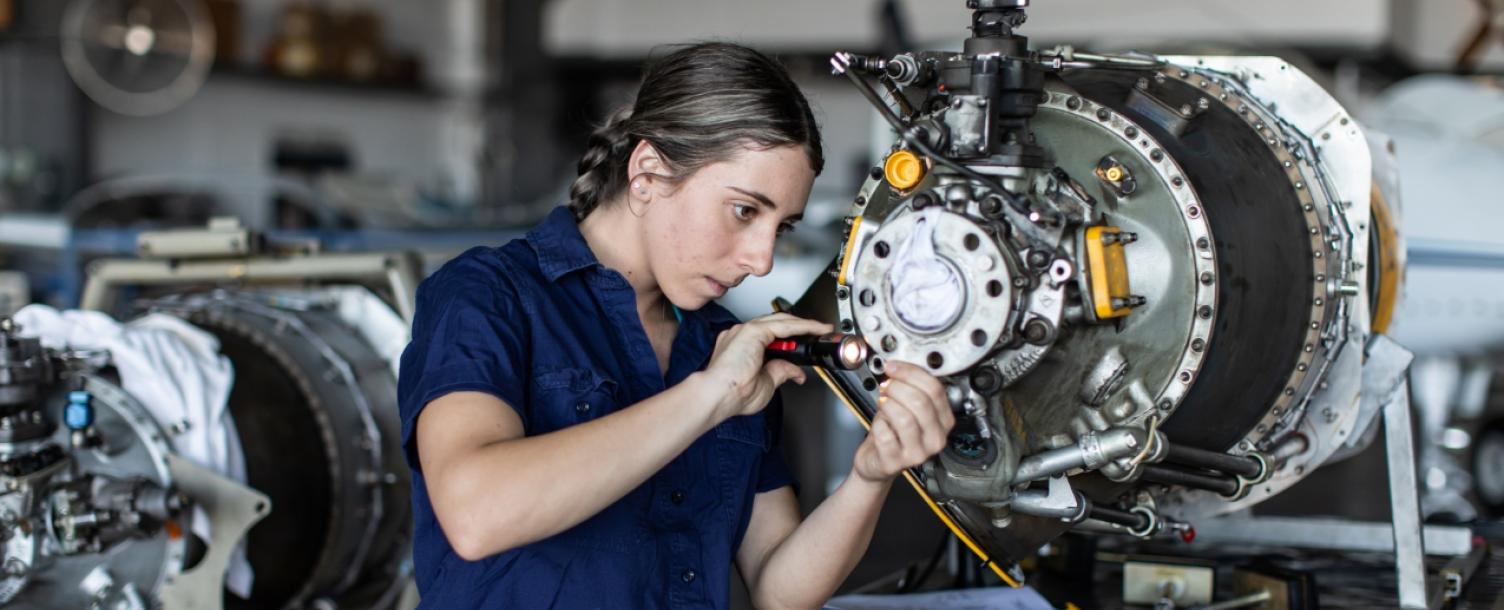 Technician working on jet engine